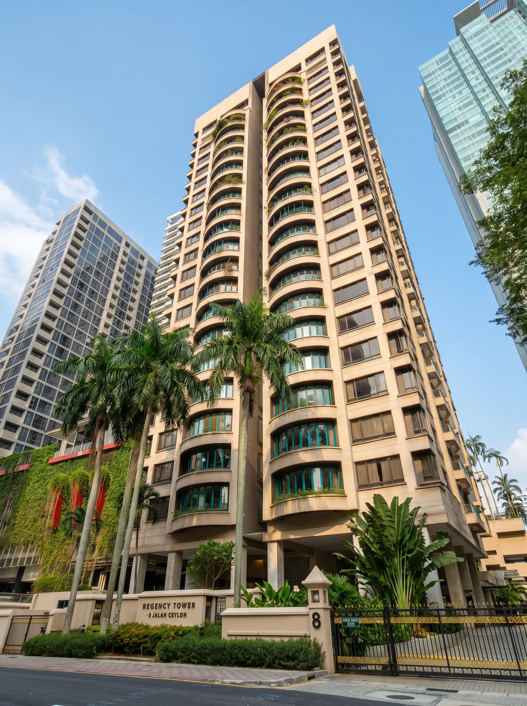 Regency Tower seen from Jalan Ceylon, with palm trees along the entrance